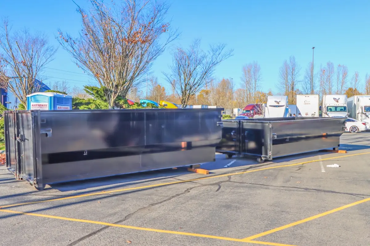 Professional dumpster rental service with roll-off container on residential driveway in Waterloo